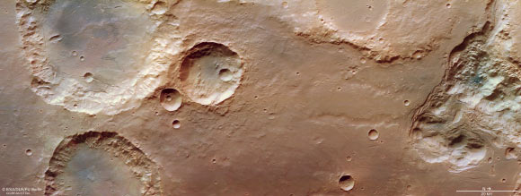 This image from the High Resolution Stereo Camera (HRSC) aboard ESA's Mars Express shows craters, canyons, and chaotic terrain at Pyrrhae Regio, Mars.  The chaotic terrain forms as a sub-surface altered layer of melting of ice and the sediments cause collapse of the surface above.  In the chaotic terrain we see here, the ice melted, the resulting water was washed away, and a number of scattered broken blocks remained standing in now-empty hollows (which once contained ice).  This image includes data collected by HRSC on August 3, 2020. Image Credit: ESA / DLR / FU Berlin / CC BY-SA 3.0 IGO.